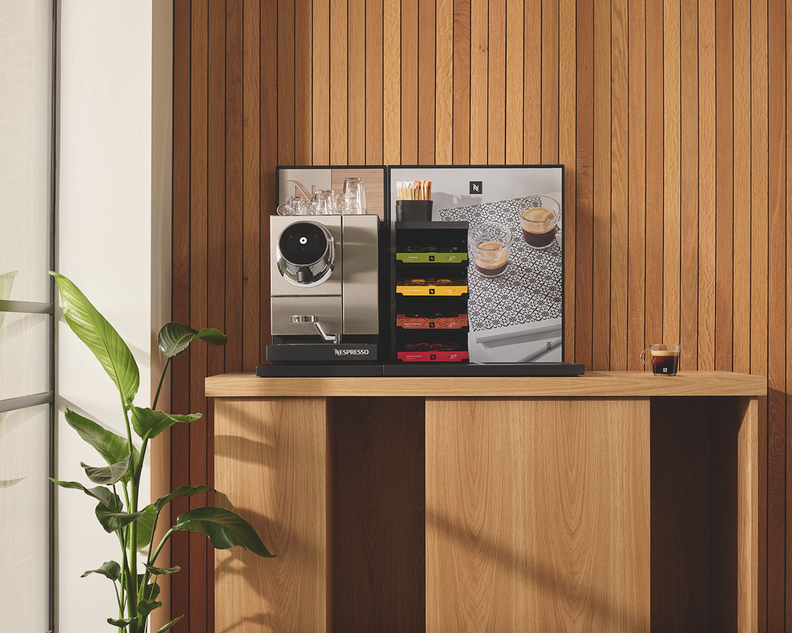 Silver Nespresso coffee machine in a modern office.