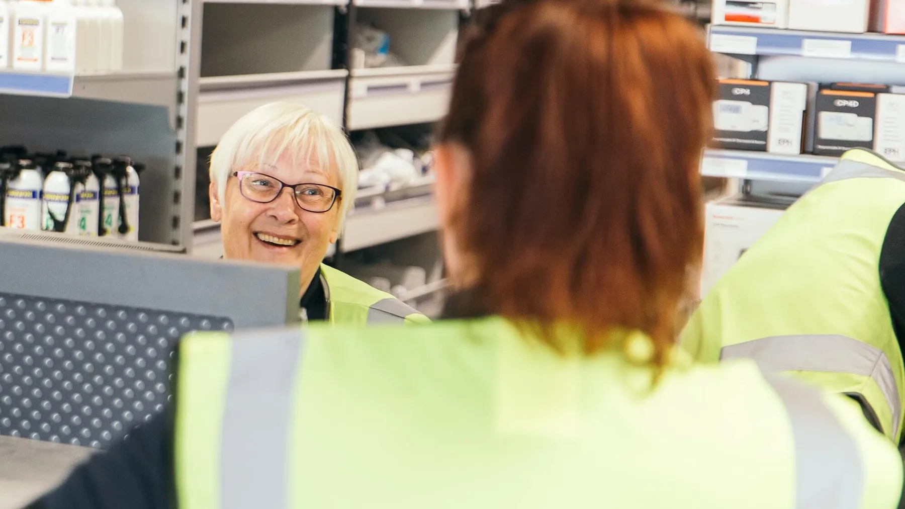 Wolseley colleagues supporting a customer at a branch counter